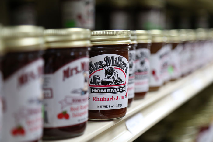 shelf with jars of Mrs. Miller's homemade rhubarb jam