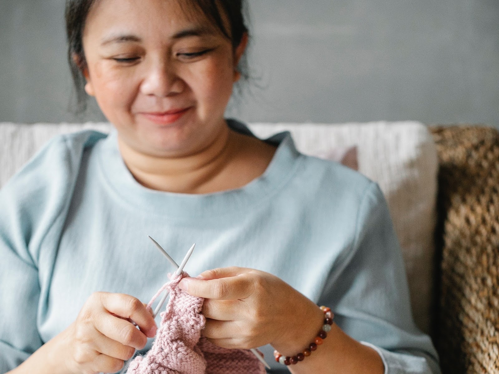 Middle-aged woman knitting in a chair