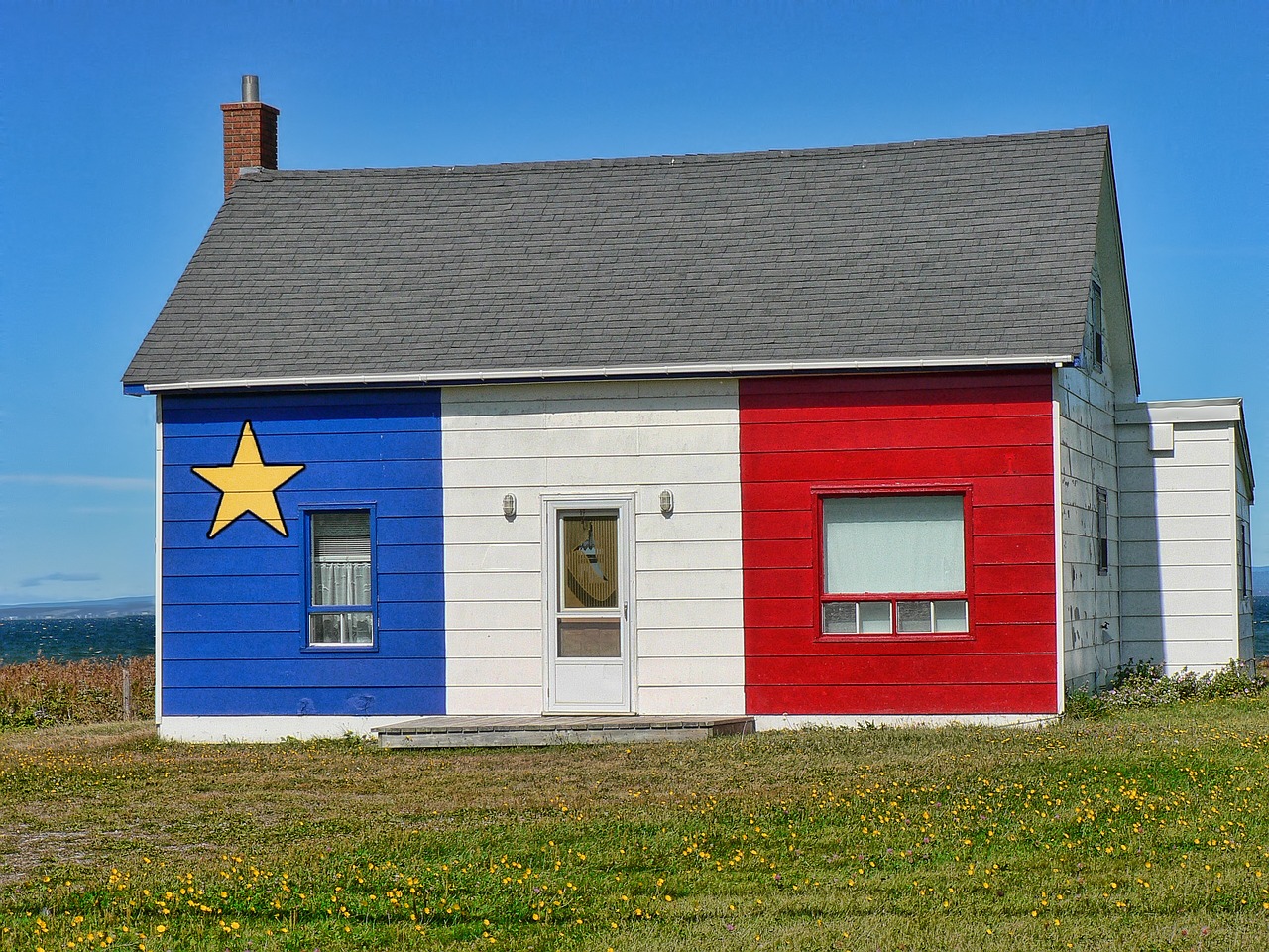 A picture of a house painted blue, white and red, the colors of the Acadian, to introduce that my father is Acadian and speaks French