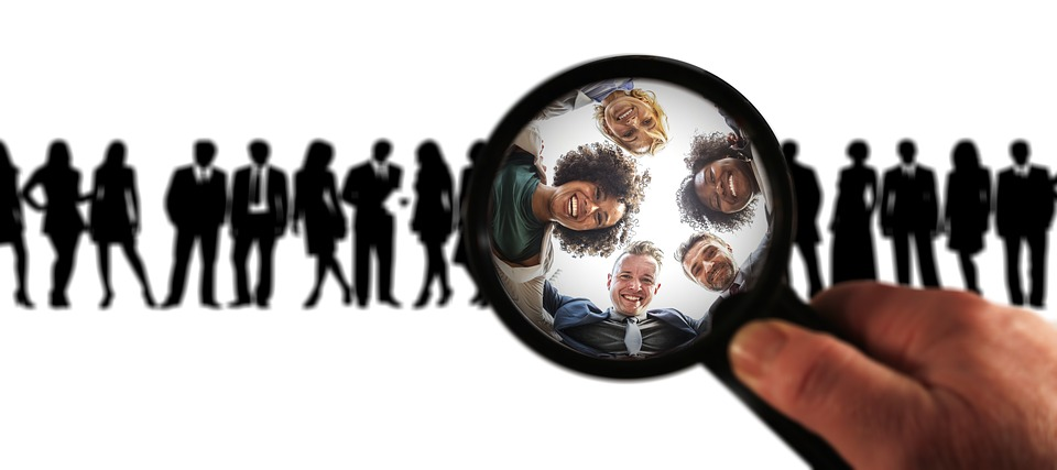 A group of people underneath a magnifying glass