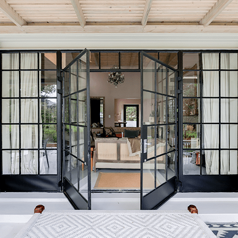 Stylish steel glass door design that adds high-end luxury and security to your house. Source: Metal Windows