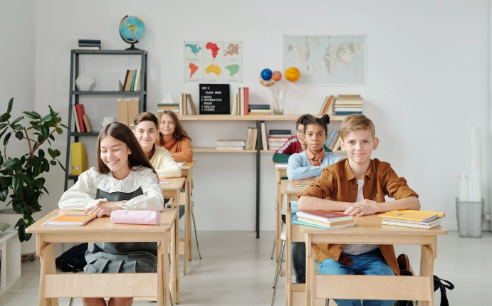 A group of students sitting in a classroom

