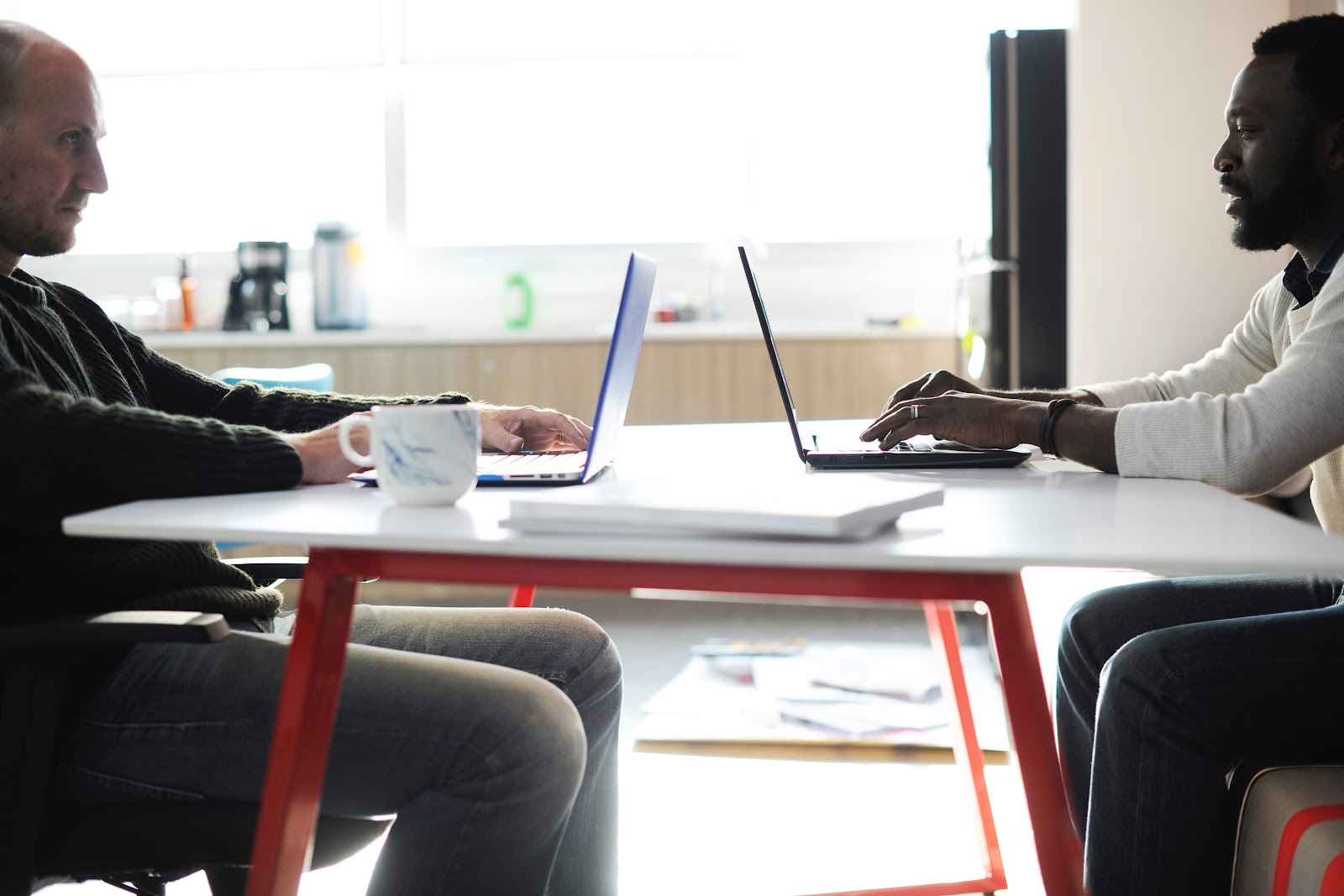 Two Man Using Laptop on Table