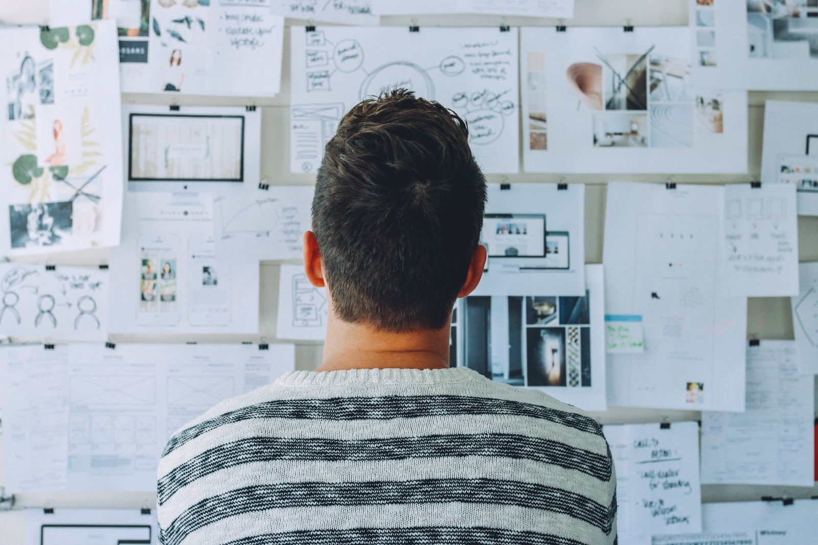 Man reading wall of papers to emphasize the benefits of creatine supplementation on the brain