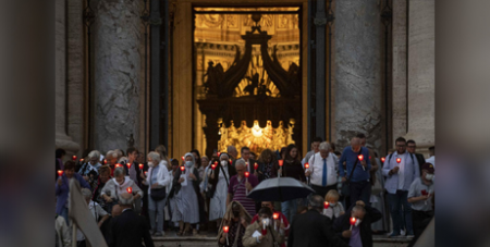 People holding lighted candles leave St Peter’s Basilica after Pope Francis celebrated Mass yesterdeay to mark the 60th anniversary of the opening of the Second Vatican Council (CNS/Vatican Media)