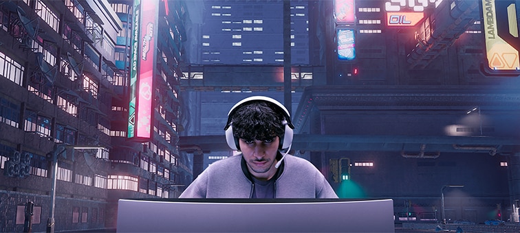Man wearing INZONE H9 headset playing games on a monitor with backdrop of game scene showing city buildings