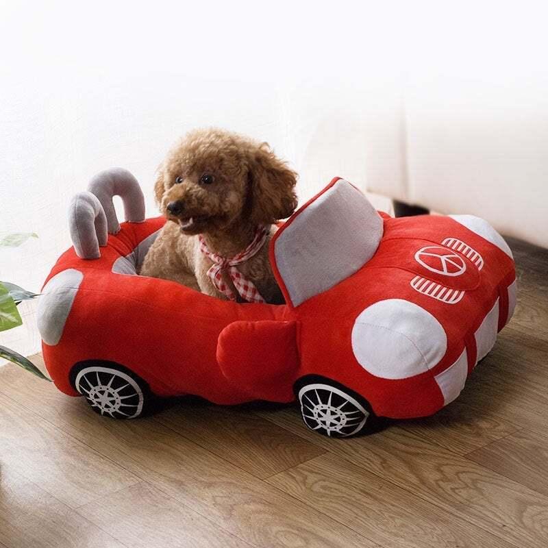 A dog in a toy car

Description automatically generated