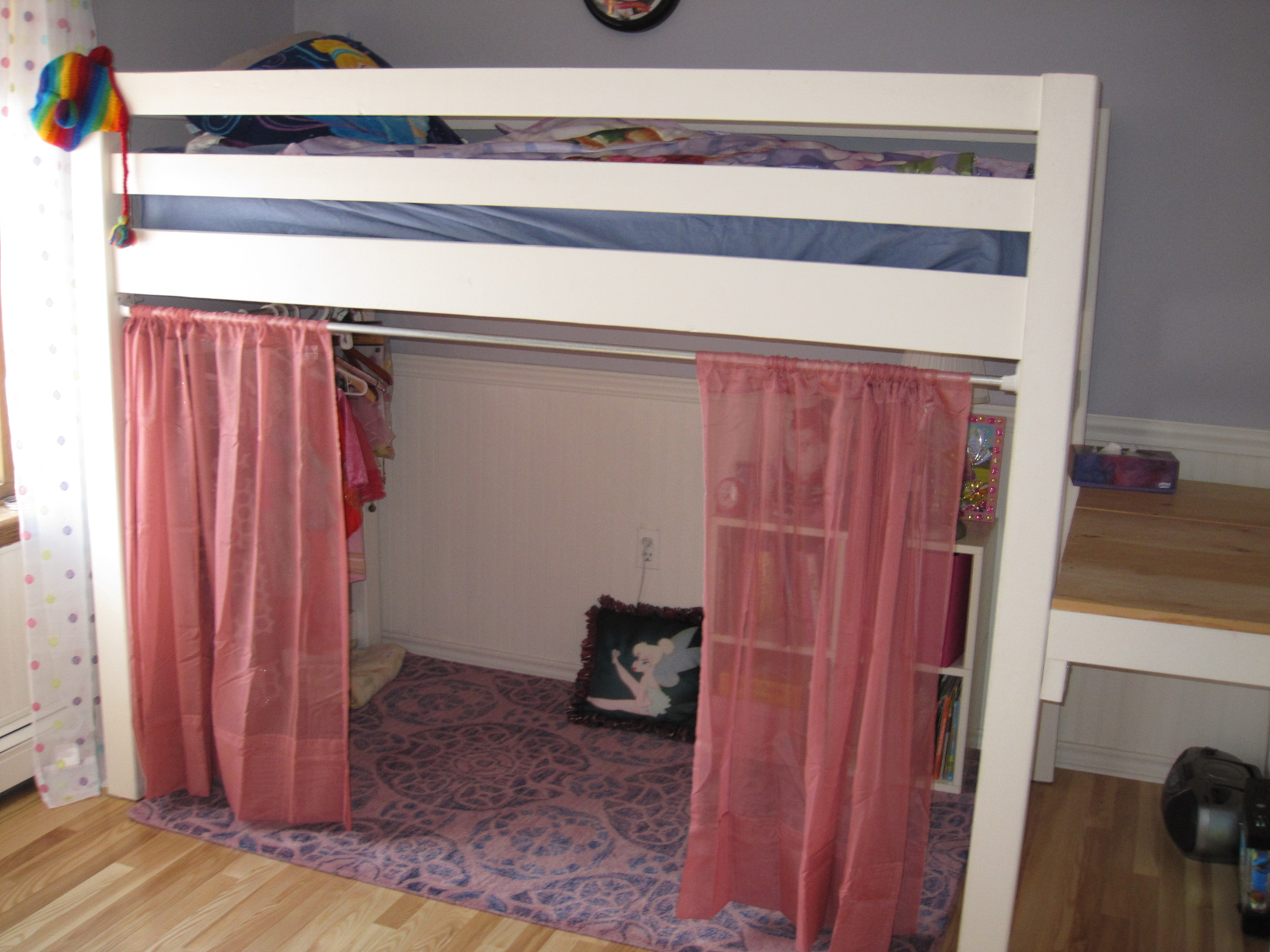 Use curtains to hide space below loft bed