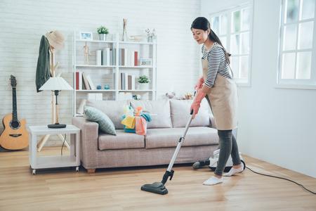 WeServe, a woman cleaning the living room with a vacuum 