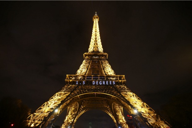 The slogan "1.5 DEGREES" is projected on the Eiffel Tower as part of the COP21, United Nations Climate Change Conference.