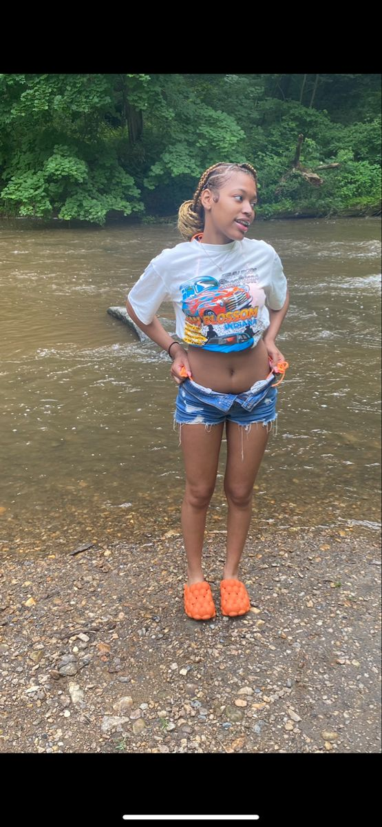 a girl standing by the riverside