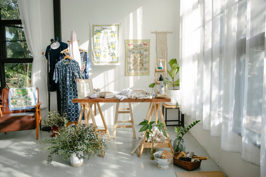 Free Interior of atelier with table and clothes on hangers Stock Photo