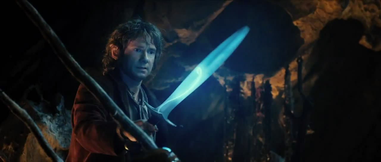 Bilbo, holding Sting, glowing blue because orcs are nearby