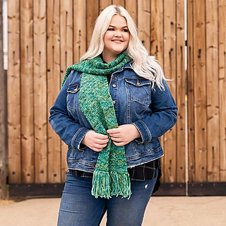 woman wearing a green reversible knit scarf outside