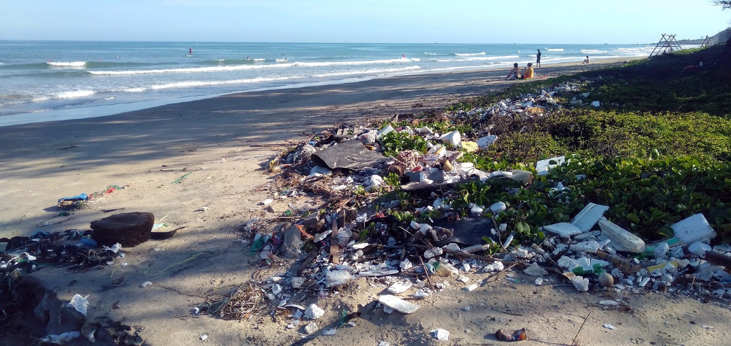 image of garbage piled up by the tide on a beach