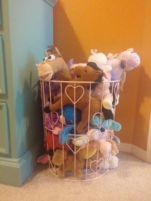 Simple stuffed animal storage idea -- use a wire basket or hamper {featured on Home Storage Solutions 101}