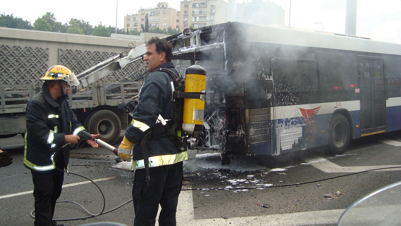 firefighters trying to put out the fire after a bus accident