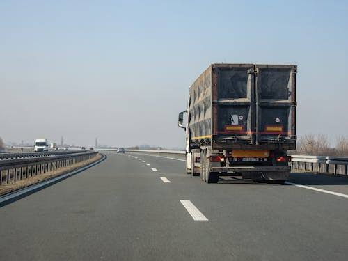 A photo of a truck on a highway.