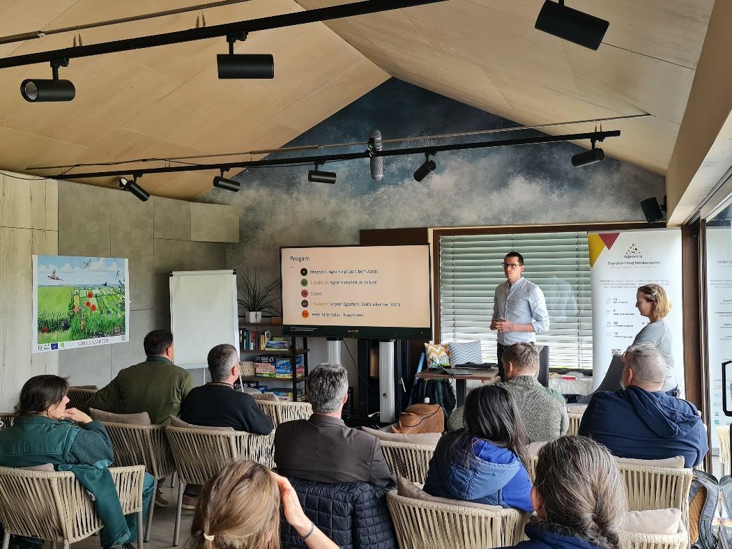 A person standing in front of a group of peopleDescription automatically generated