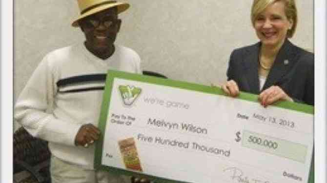 Melvyn Wilson happily receiving the lottery of $500,000
