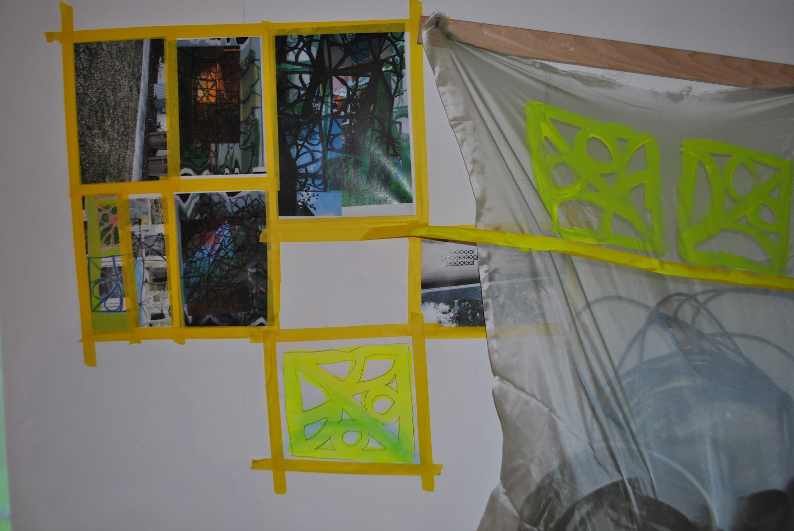 Image: Kelly Clare, enter / the net / here, 2022, Edna Carlsten Gallery. Six images and one drawing are taped onto the wall with yellow tape. A sheer piece of fabric with painted fluorescent yellow breeze blocks hangs next to the images. Image courtesy of the artist.