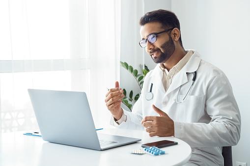 A doctor looking at a computer

Description automatically generated with low confidence