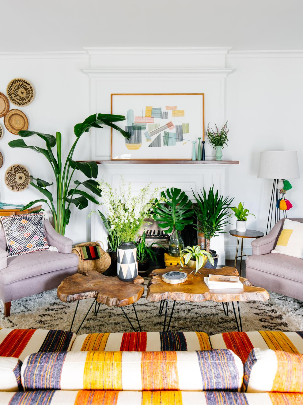Bohemian themed living room with a colorful couch and natural wood top coffee table