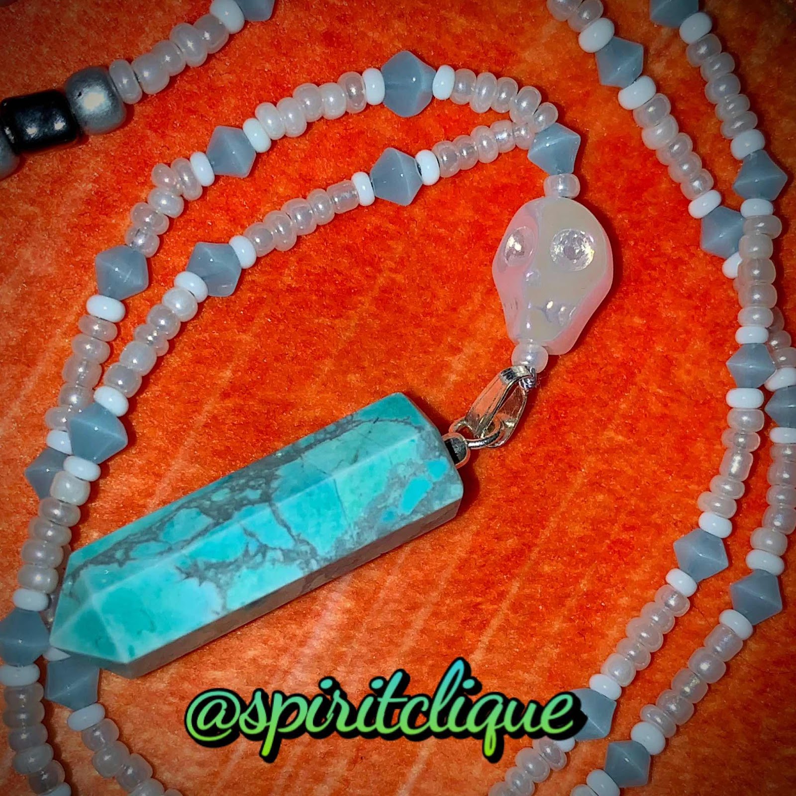 howlite crystal, magnesite blue crystal & skull bead with microbeads and cats eyes