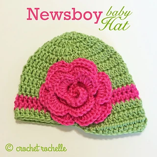 green and pink newsboy hat lying flat on a white background