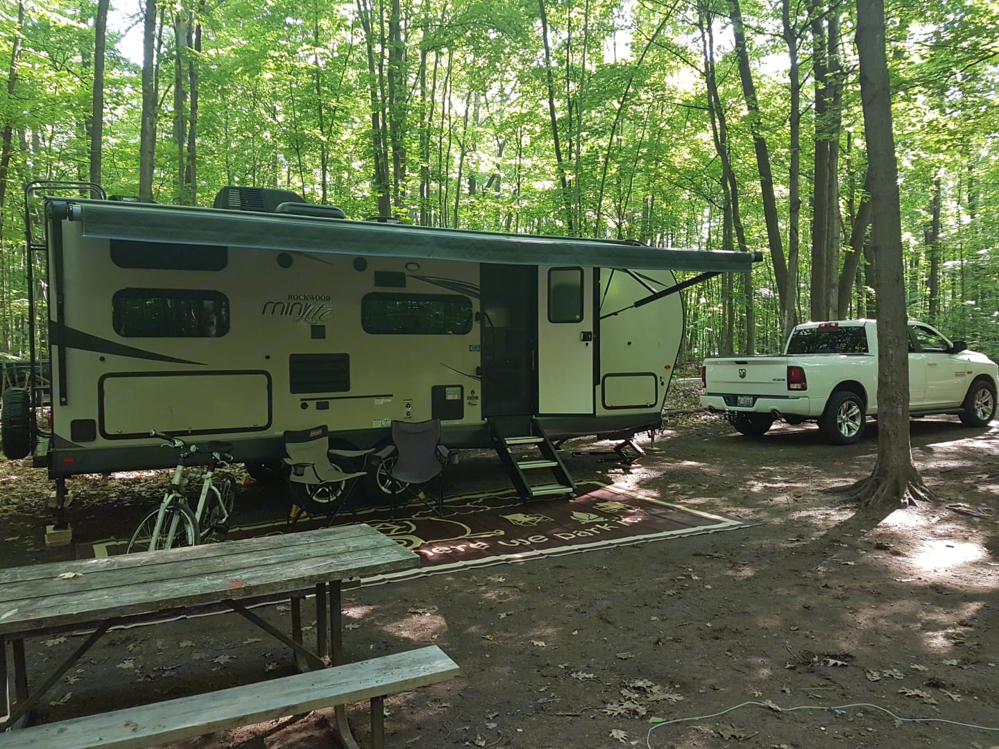 Travel trailer in wooded campsite