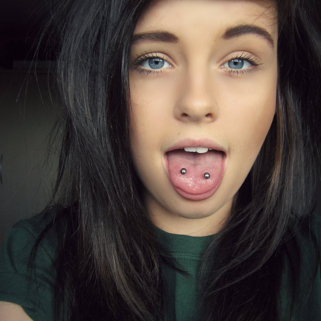 Lady with blue eyes shows off her double tongue with style