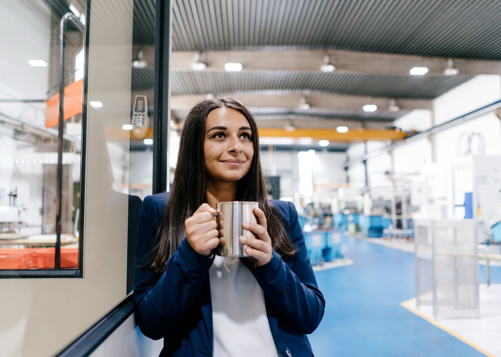 Confident woman working in a high tech enterprise, demonstrating how managed IT has evolved.