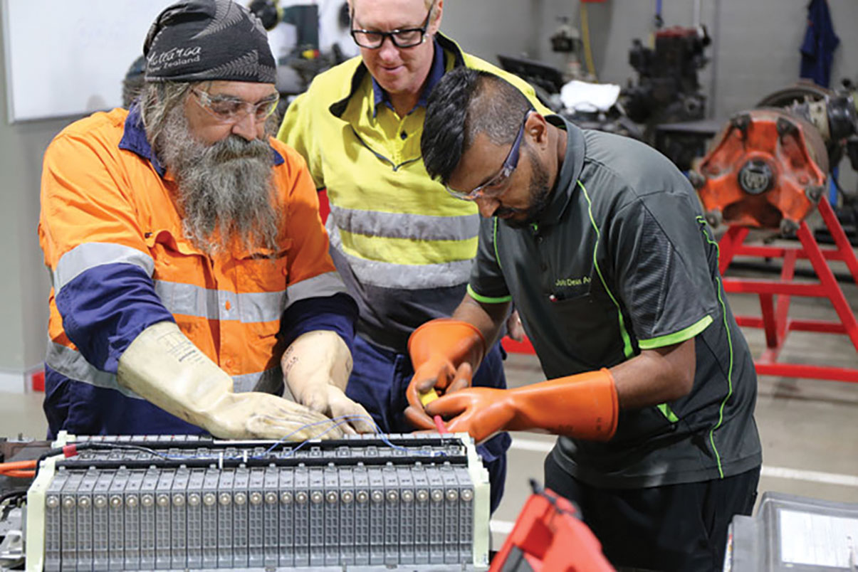 Mechanic fixing electric car battery