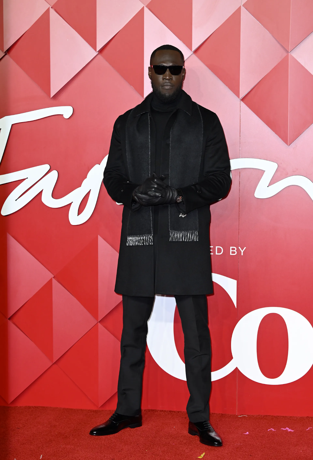 Stormzy wearing a black ensemble at the Fashion Awards 2022