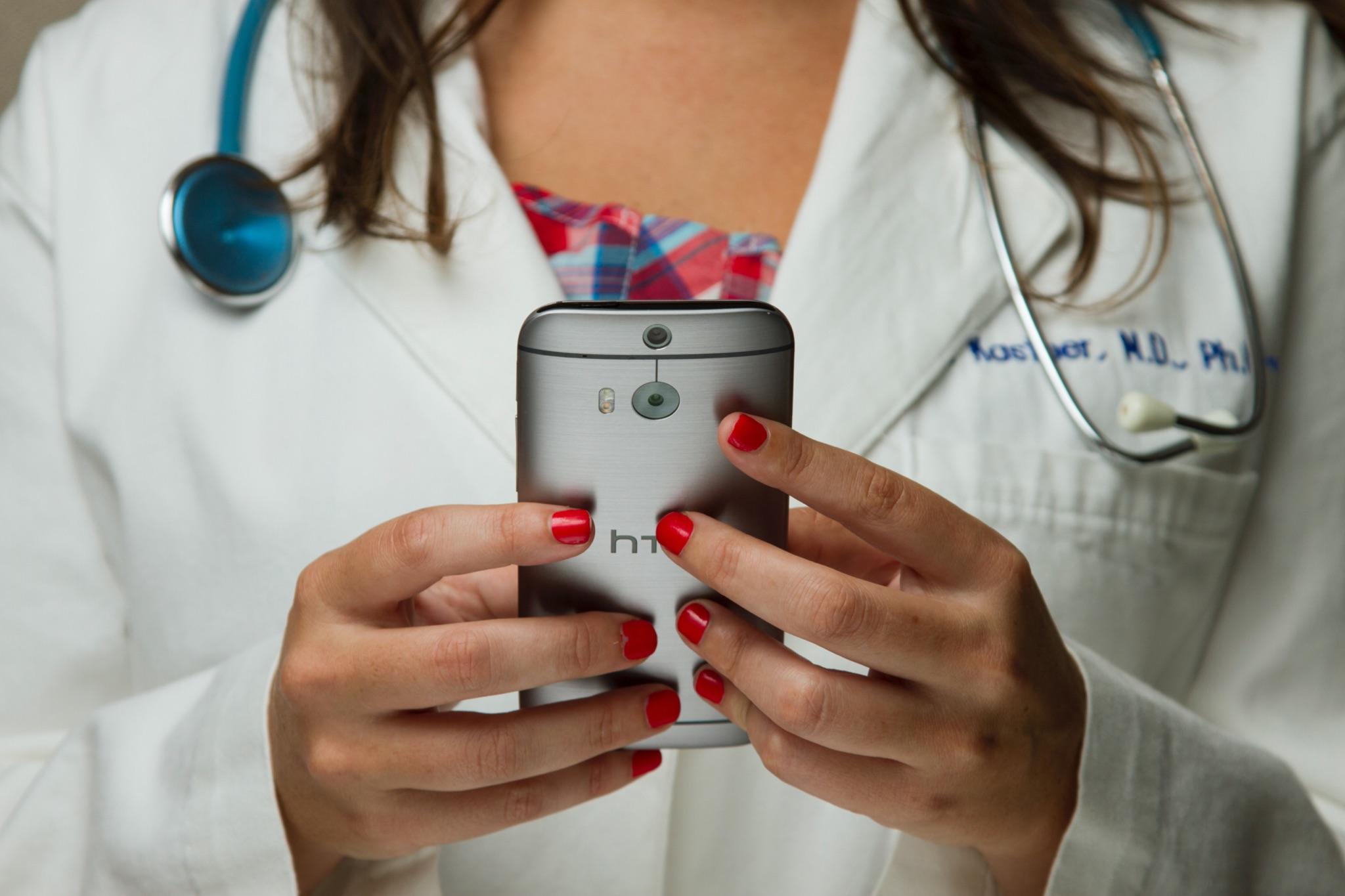 Close-up doctor’s hands holding a phone