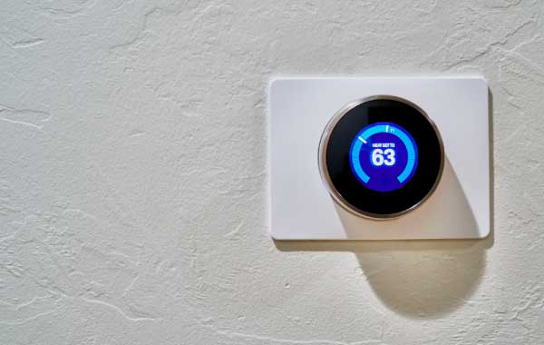 Smart thermostat set to 63 degrees fahrenheit