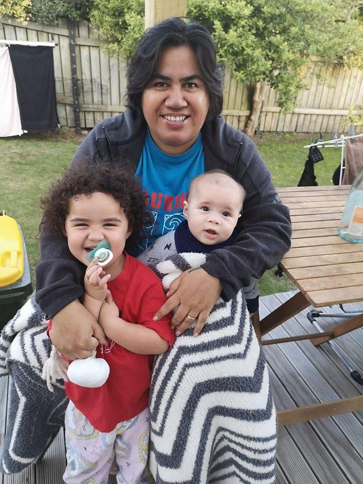 A person holding a baby Description automatically generated