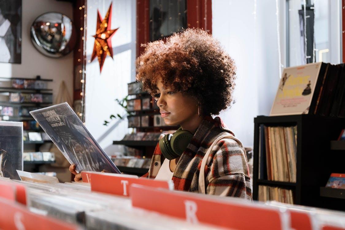 Free Woman in Red and White Plaid Shirt Checking the Vinyl Record Stock Photo