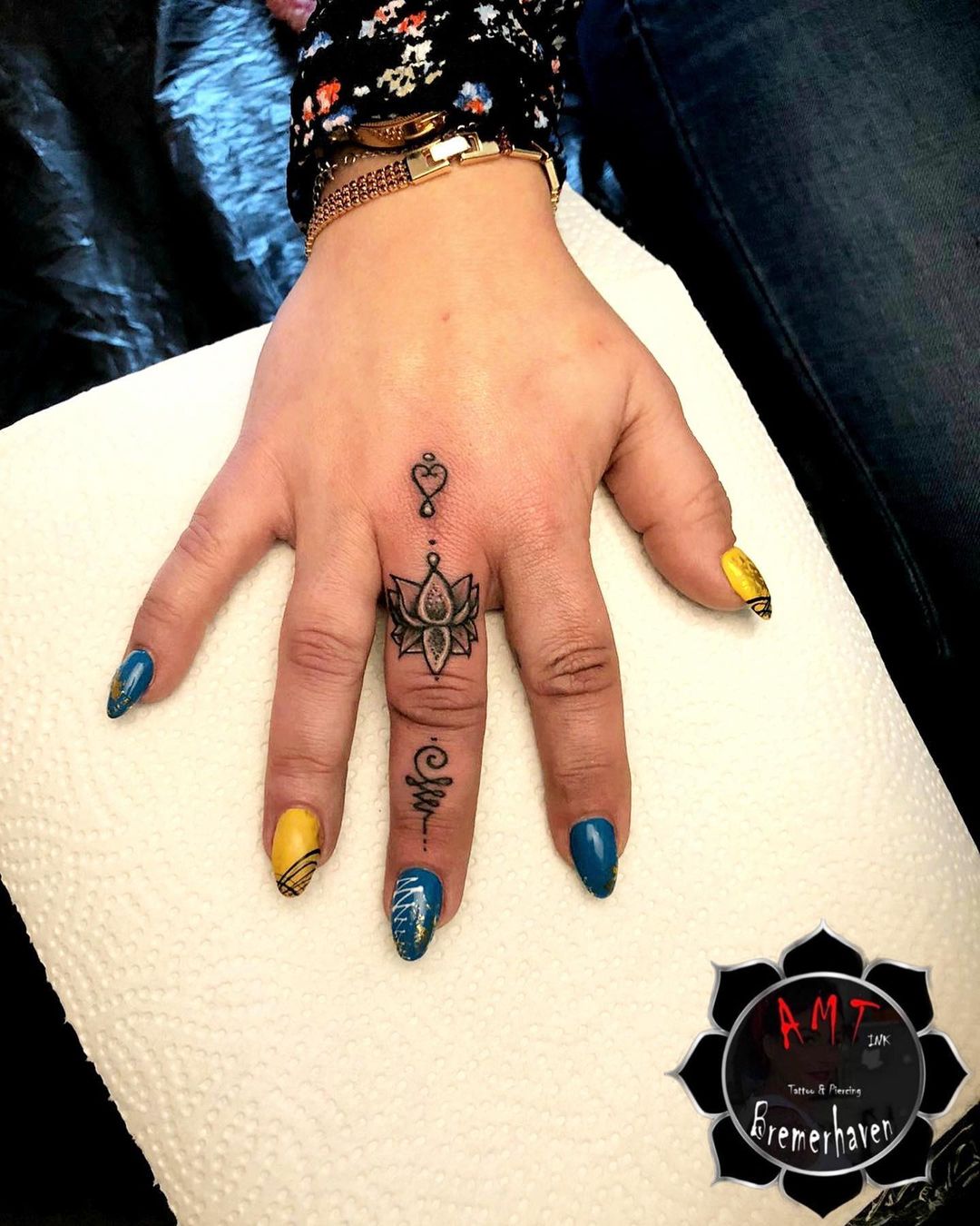 mandala tattoo on finger 
