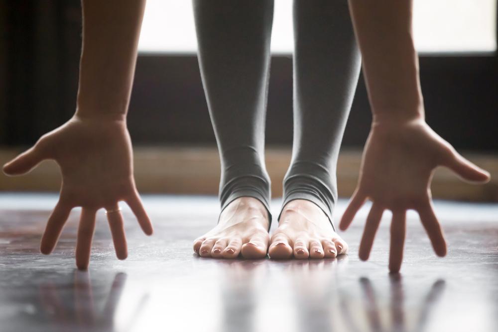 https://yogateachercentral.com/wp-content/uploads/2018/03/teacher-close-up-uttanansana-new-open-discipline-shutterstock_557795215.jpg