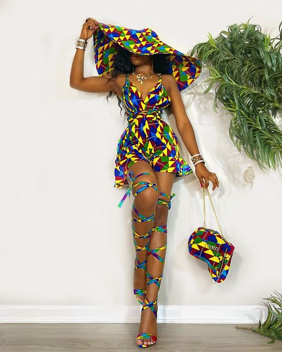 lady wearing wide-brimmed ankara hat with matching short gown and bag