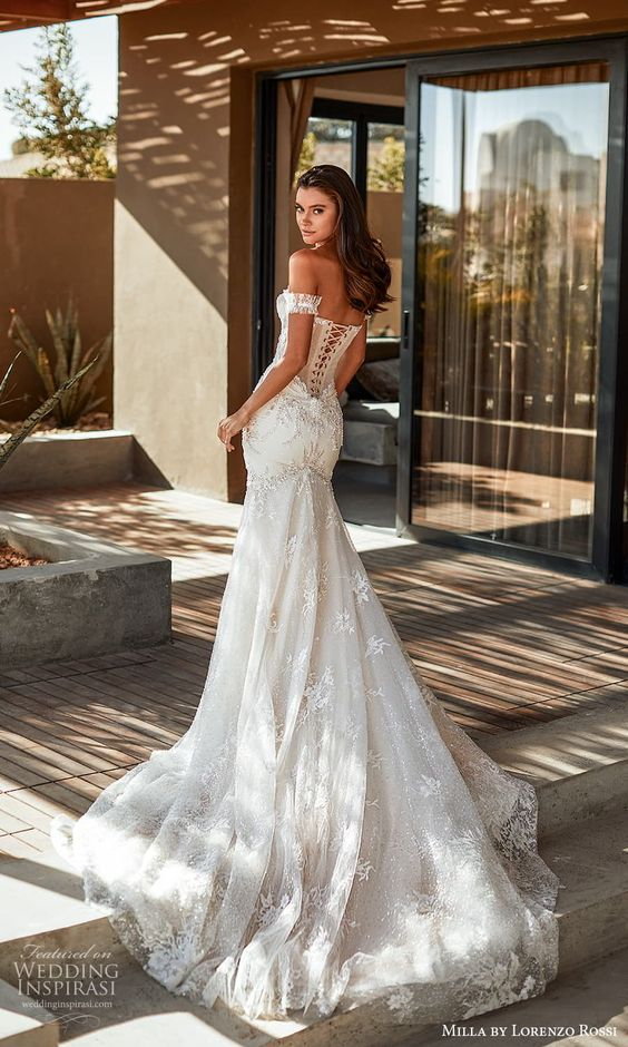 a lady wearing a corset wedding gown and showing the lace-ups behind