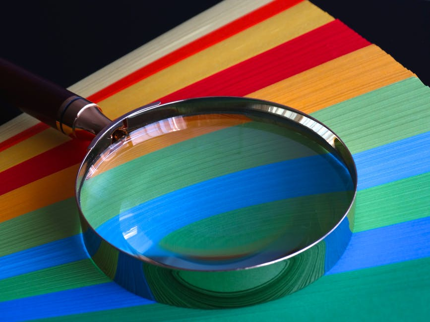 Magnifying glass on multicoloured card