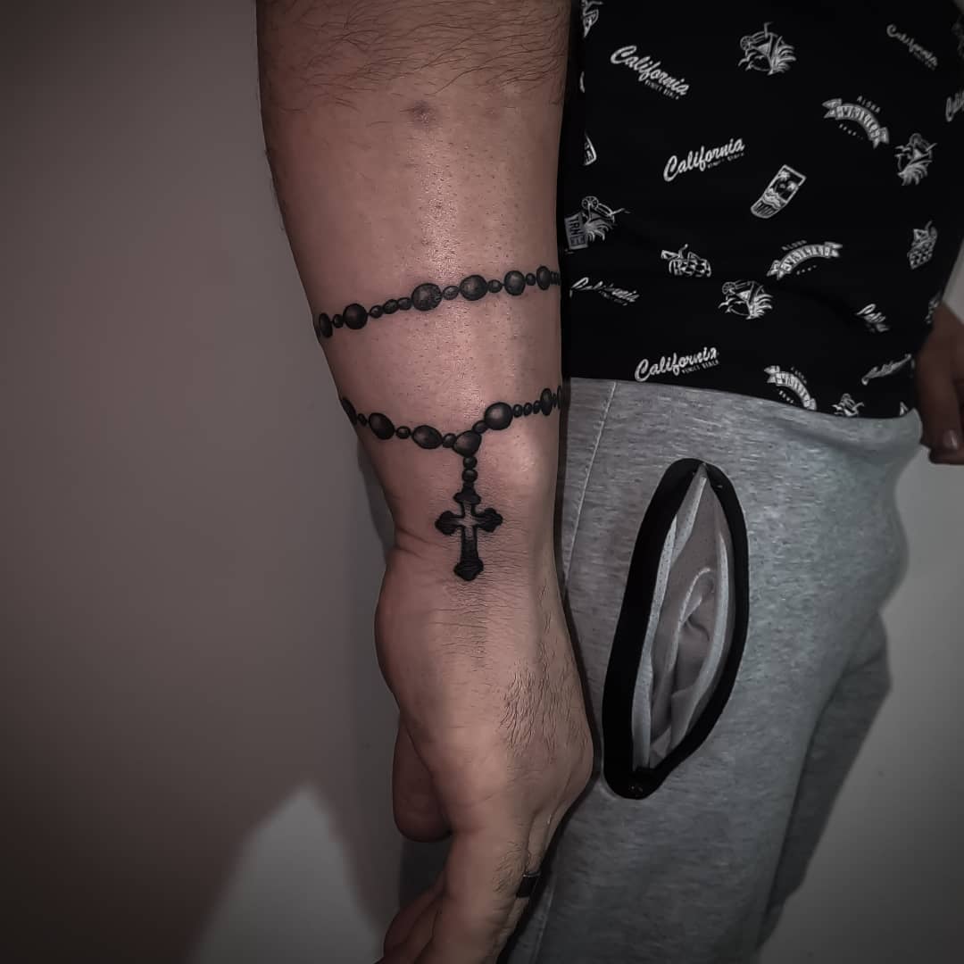 rosary tattoo on arm