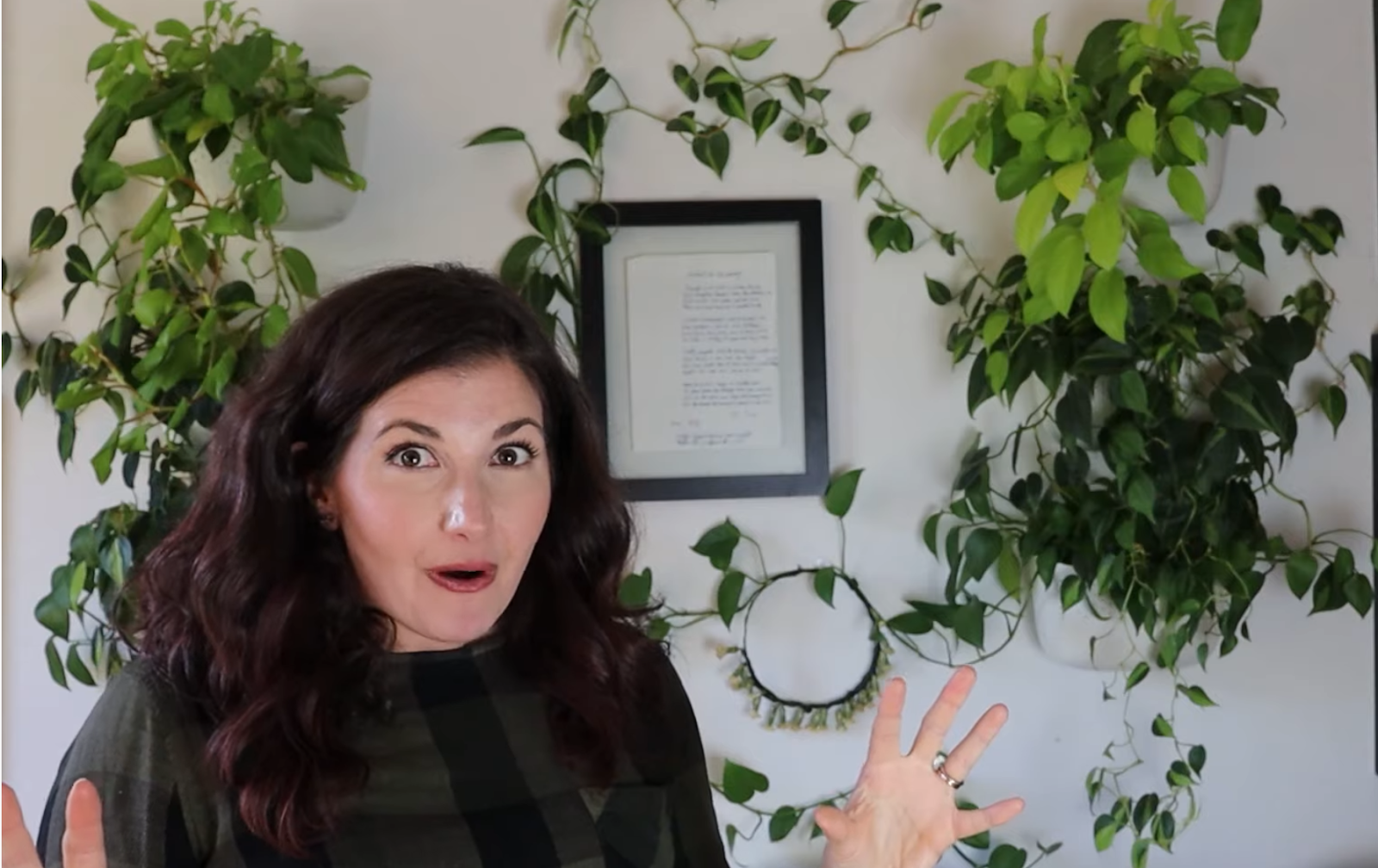 Woman in front of climbing plants