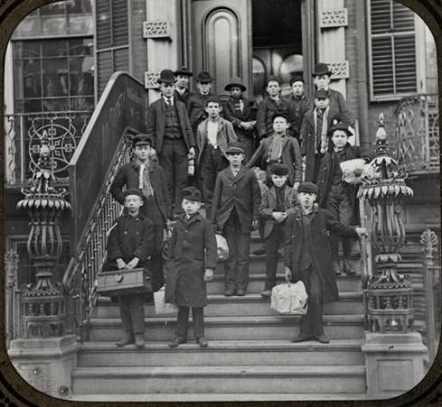 A group of people posing for a photo on the steps of a building

Description automatically generated with medium confidence