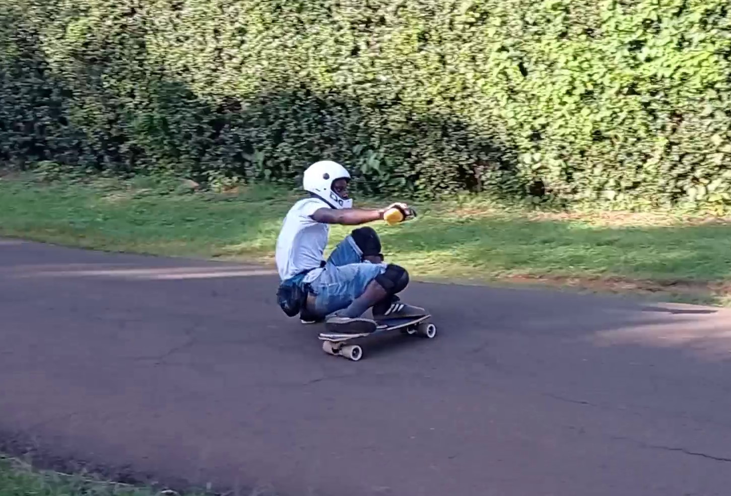 Abuga sliding his longboard on the Pro-Fluxx