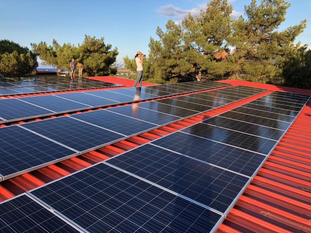 A person standing on a solar panel

Description automatically generated with medium confidence