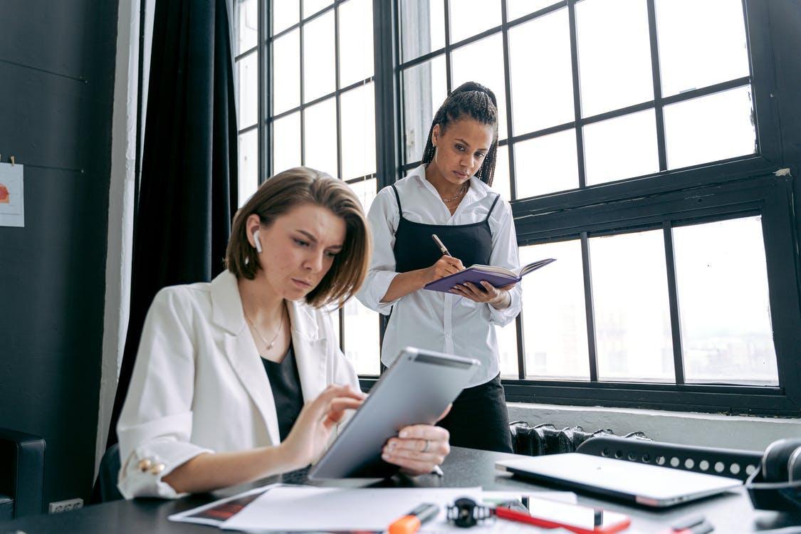 Free Women Working in an Office and Using Tablets  Stock Photo