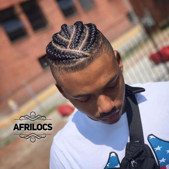 Man with fade haircut and cornrow braid hairstyle for men